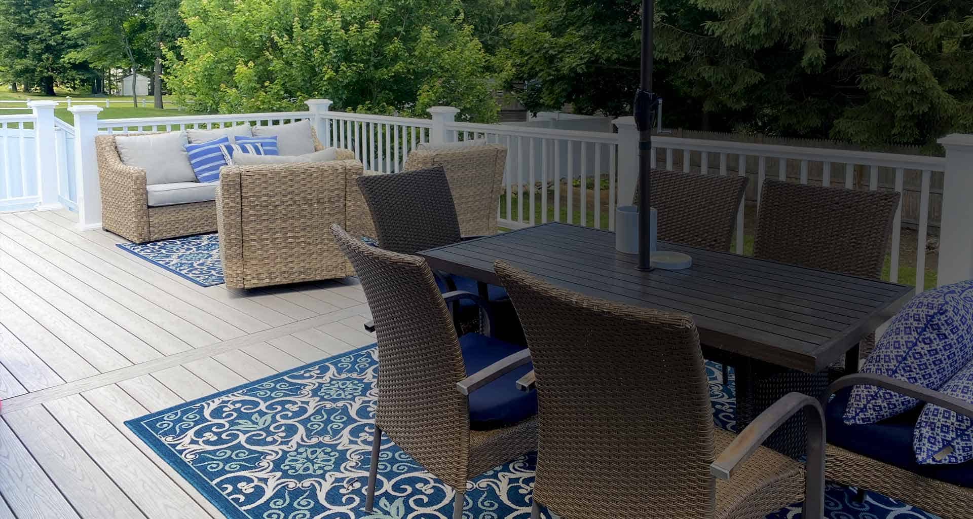 A grey deck with blue furniture